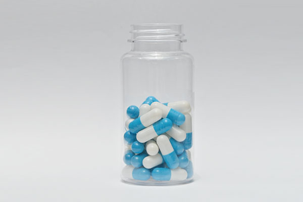 a bottle of blue capsules