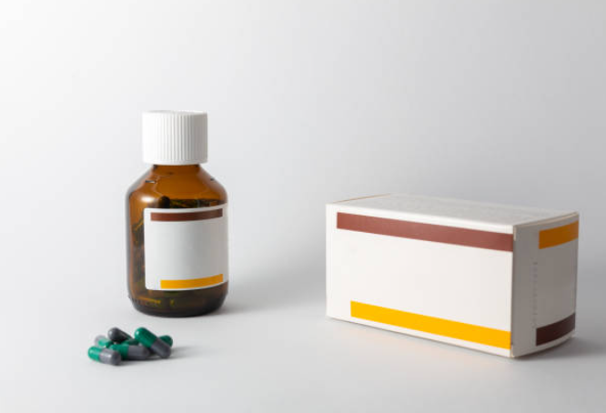 a medicine bottle, a medicine box and some capsules