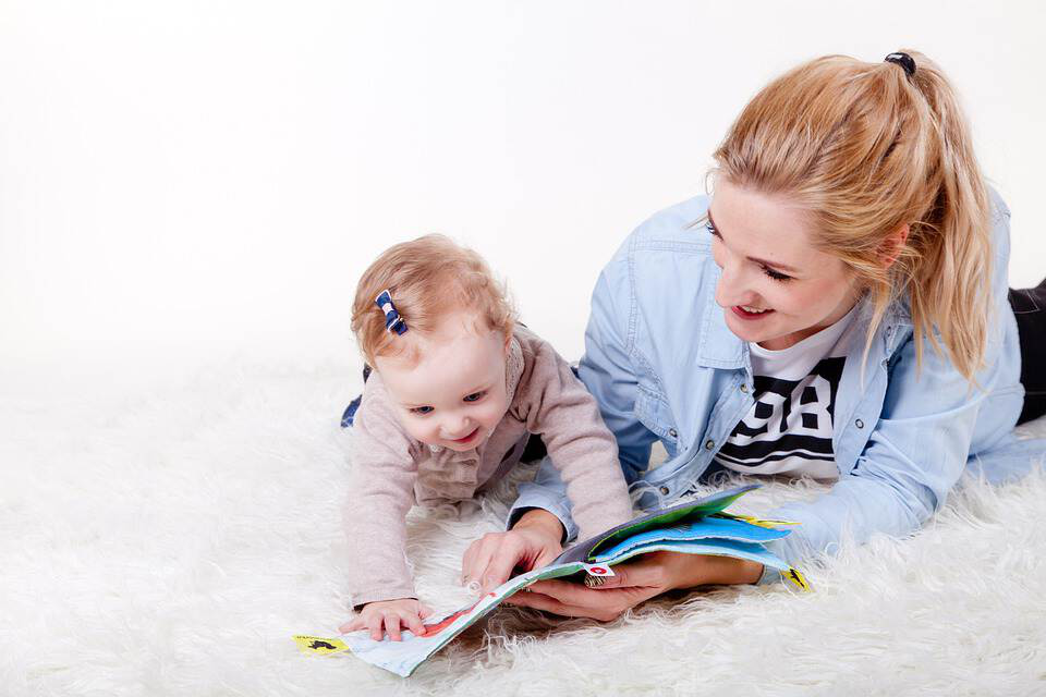 A mother and daughter reading the book