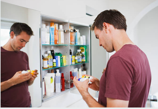 a man reading the medicine lable