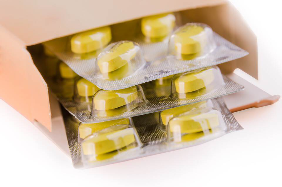 yellow tablets in the little box