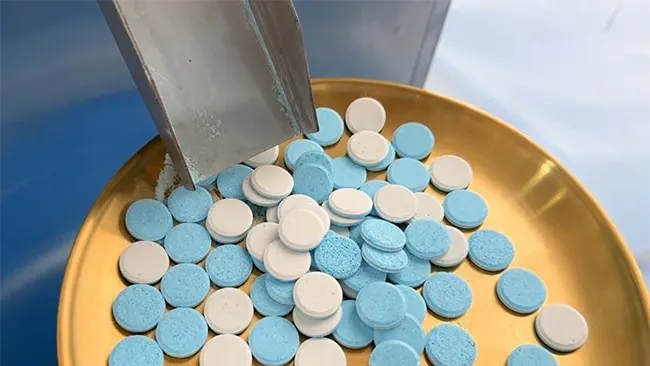 tablet press discharge bilayer tablet