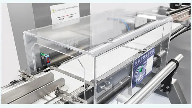 Close-up of a checkweigher conveyor with transparent protective cover