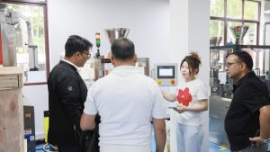 Sales Executive Emmy discussing capsule filling machine maintenance requirements with the client.