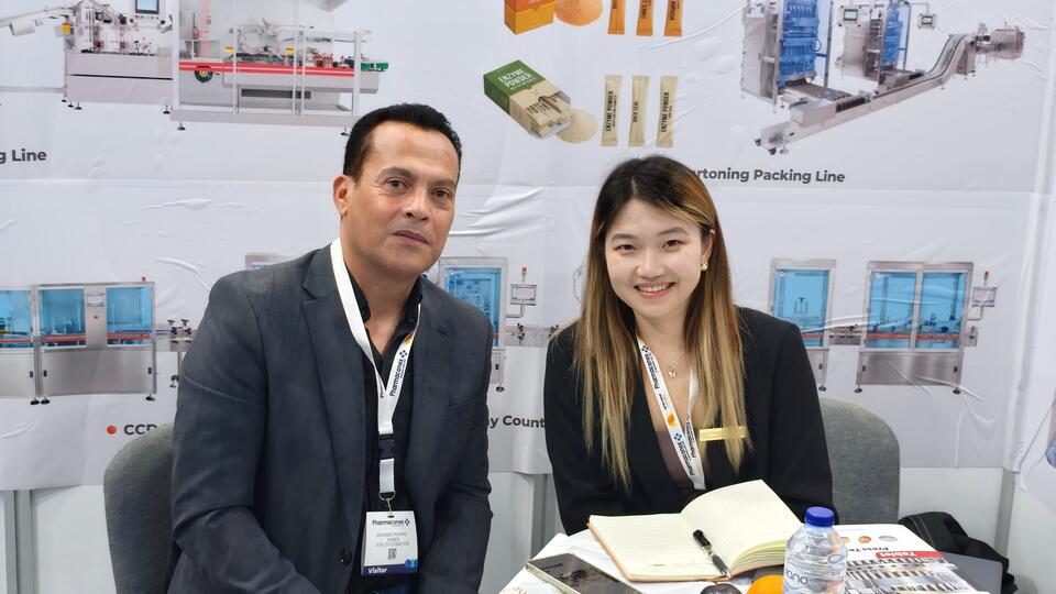 Ruida Packing Sales Manager Sara taking a photo with clients at Pharmaconex 2026 Egypt exhibition